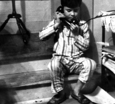 Homer "Sonny" Hickam, Jr., talks to his dad on the coal mine black phone, 1948.
